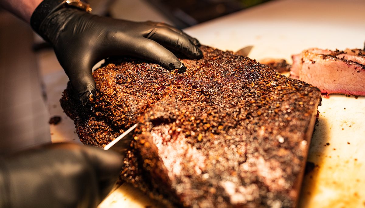 Slicing into smoked brisket.