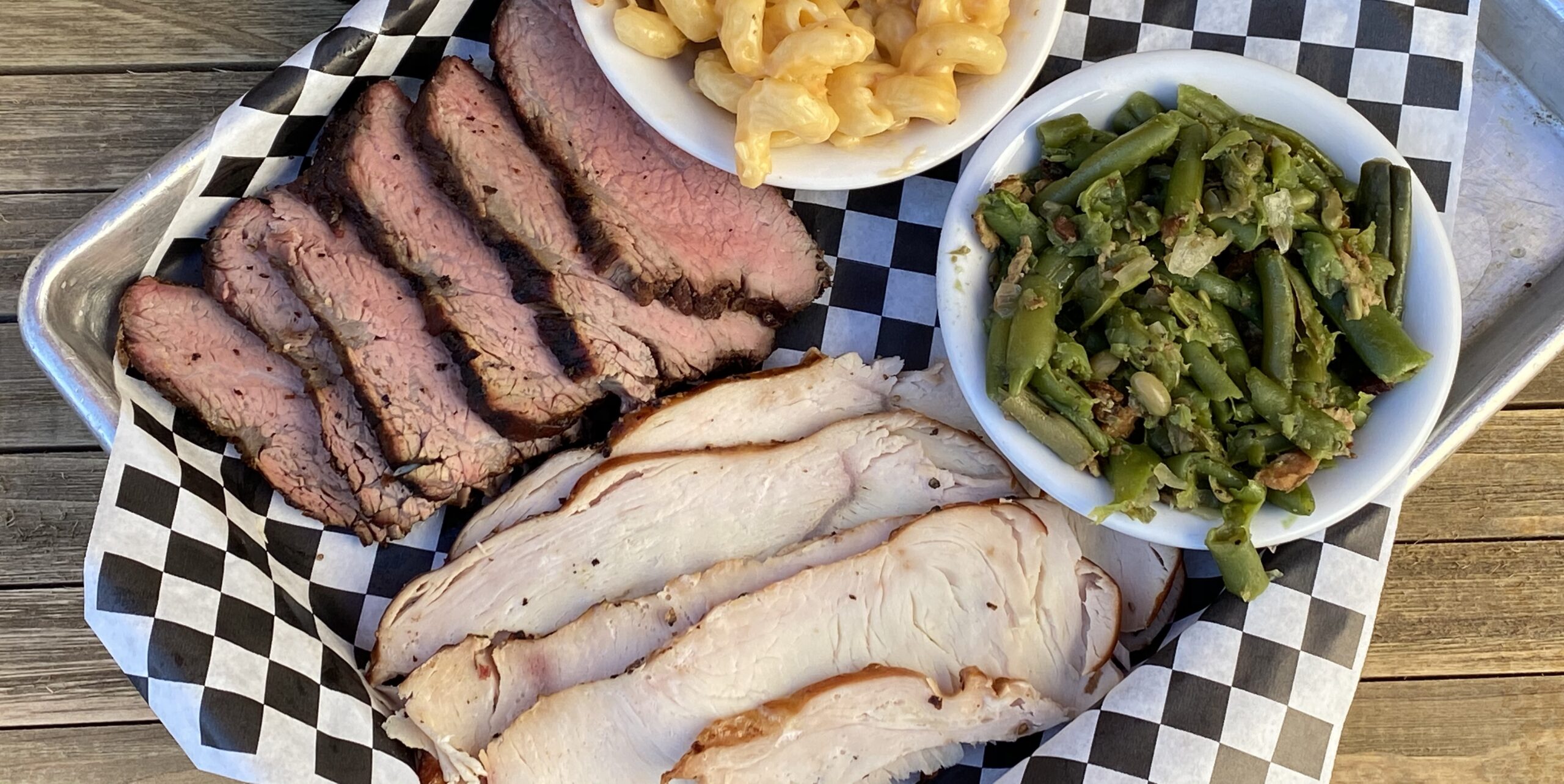 Two meat plate with smoked tri tip and smoked turkey breast with a side of smoked green beans and our bacon mac & cheese