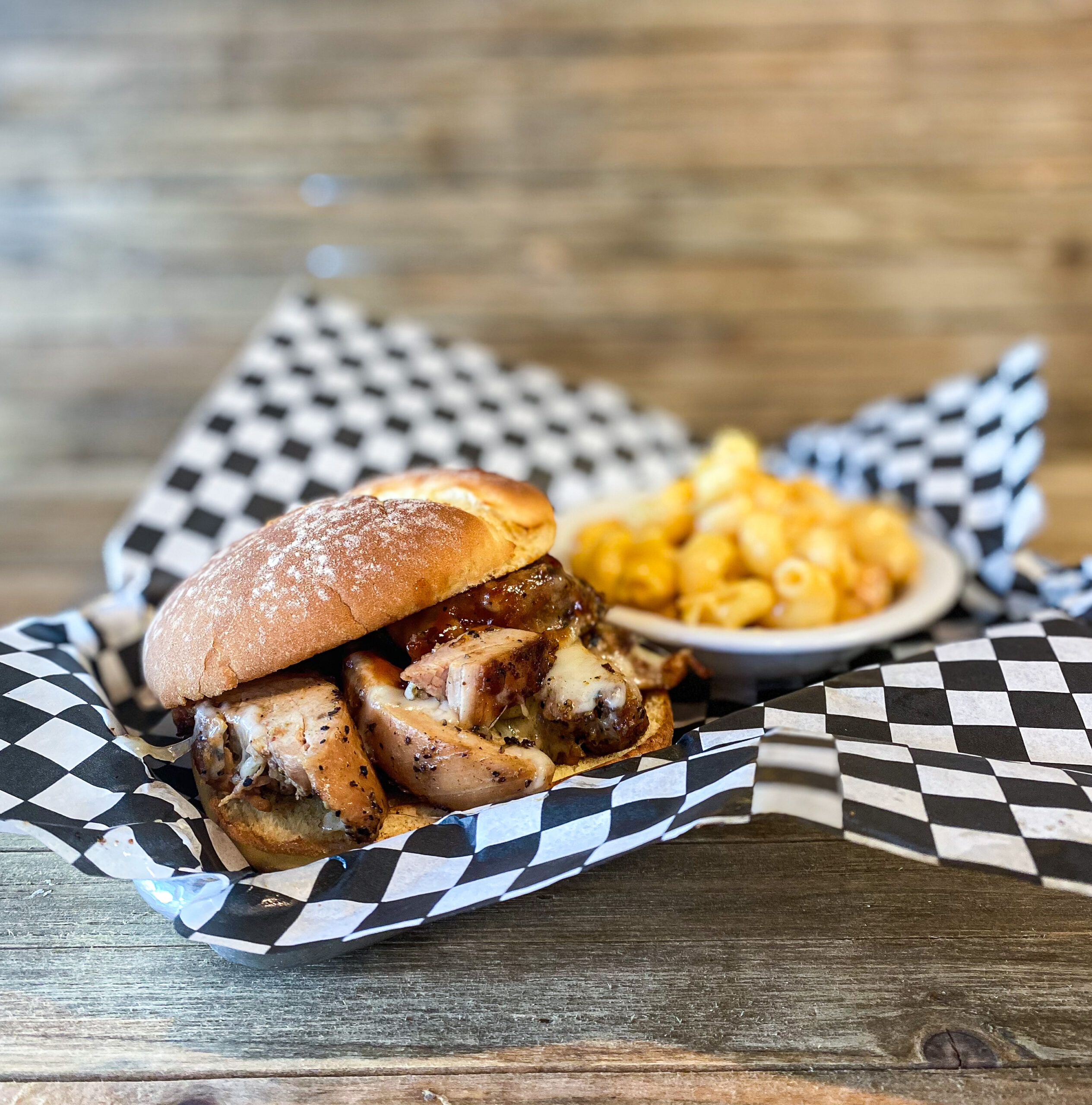 Our chopped and smoked chicken thigh on a toasted potato bun with sweet bbq sauce and monterey jack cheese.